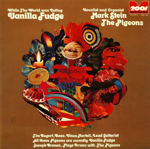 Cover The Pigeons (2) - While The World Was Eating Vanilla Fudge (LP, Album) Schallplatten Ankauf