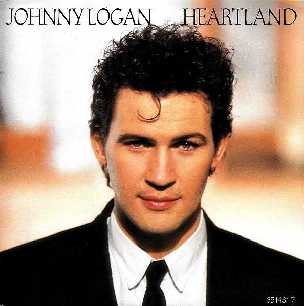 Cover Johnny Logan - Heartland (7, Single) Schallplatten Ankauf