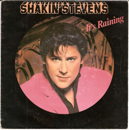 Cover Shakin' Stevens - It's Raining (7, Single) Schallplatten Ankauf