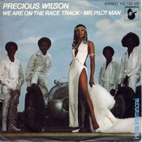 Cover Precious Wilson - We Are On The Race Track / Mr. Pilot Man (7, Single) Schallplatten Ankauf